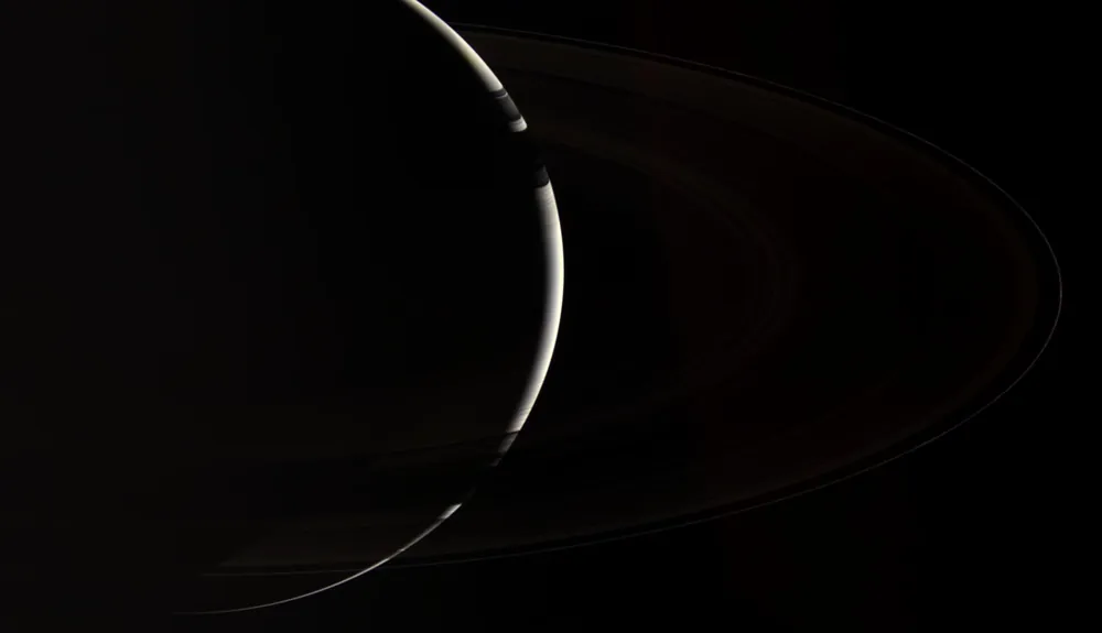 Crescent Saturn and its rings from Cassini.