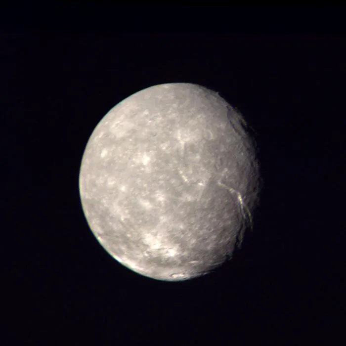 Titania, the largest moon of Uranus, from Voyager 2.