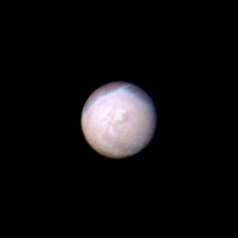 Neptune's largest moon Triton and its cantaloupe terrain, from Voyager 2.