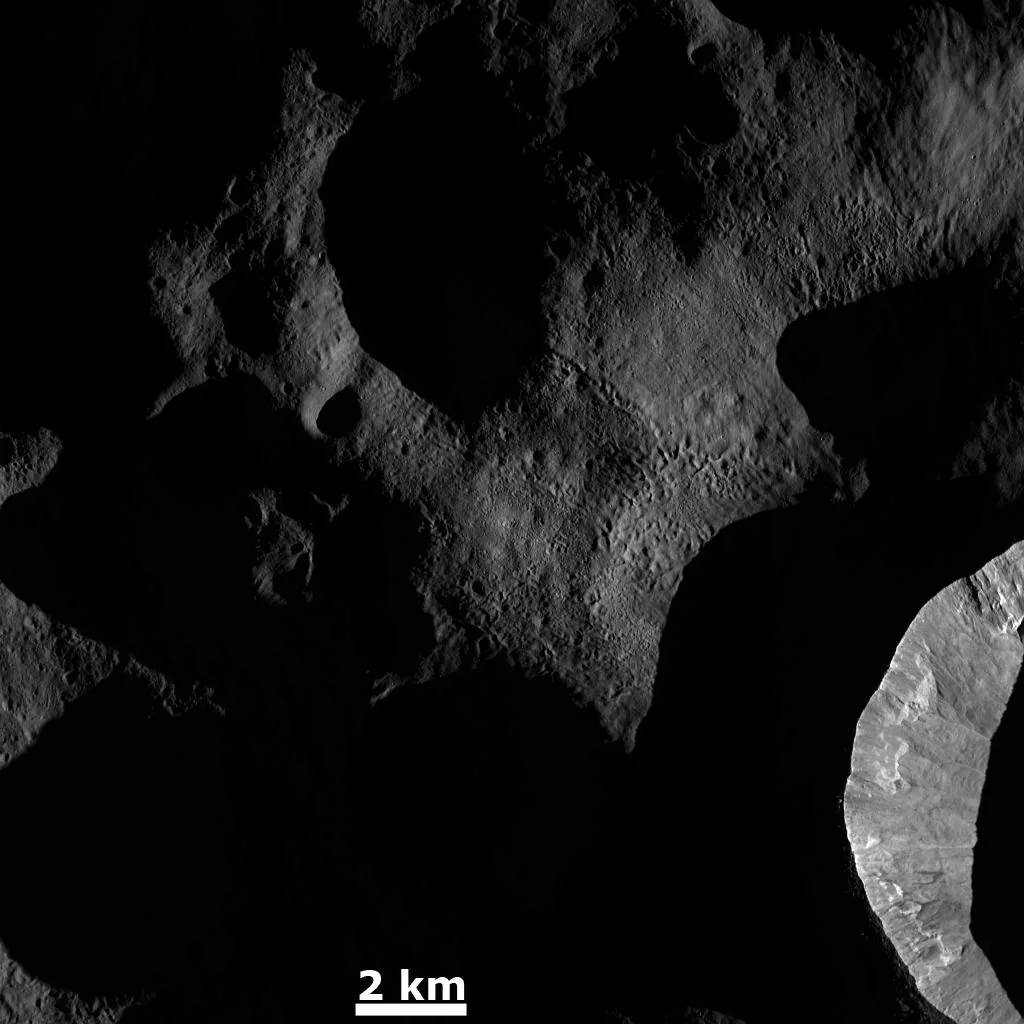 The giant asteroid Vesta and its grooved southern hemisphere, from Dawn.